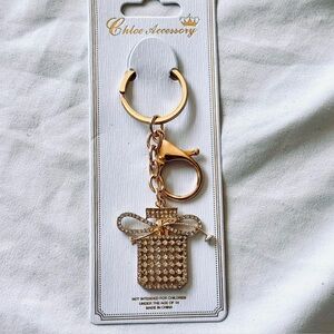 BAG CHARM Gold Tone Glittering Perfume Bottle With Bow Keychain